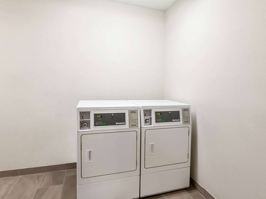 A laundry area with two stacked front-loading washing machines.