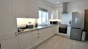 Two-Bedroom Apartment with Private Terrace - Ground Floor | Private kitchen | Full-size fridge, microwave, oven, stovetop