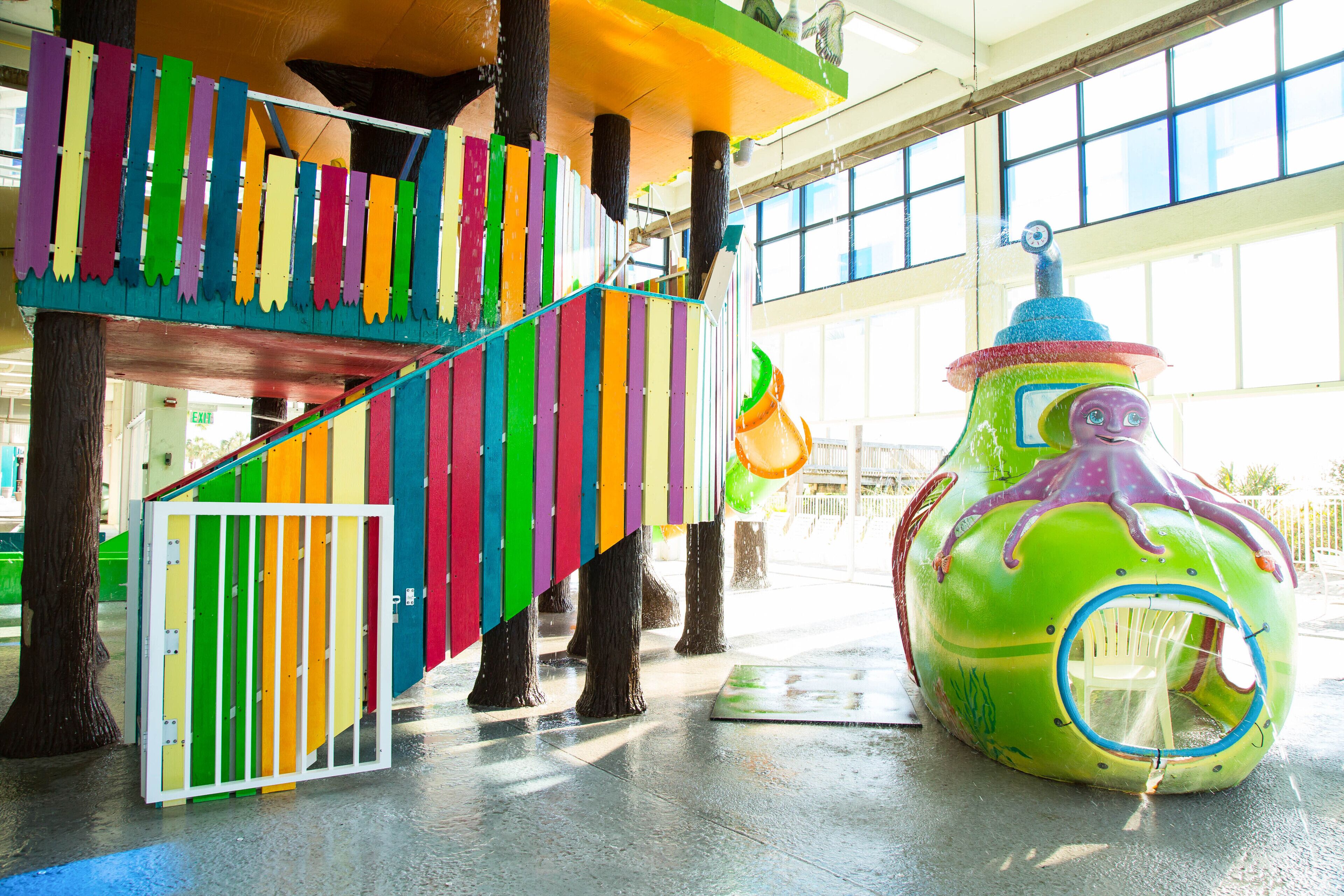 A colorful play structure with a slide and a climbing area.