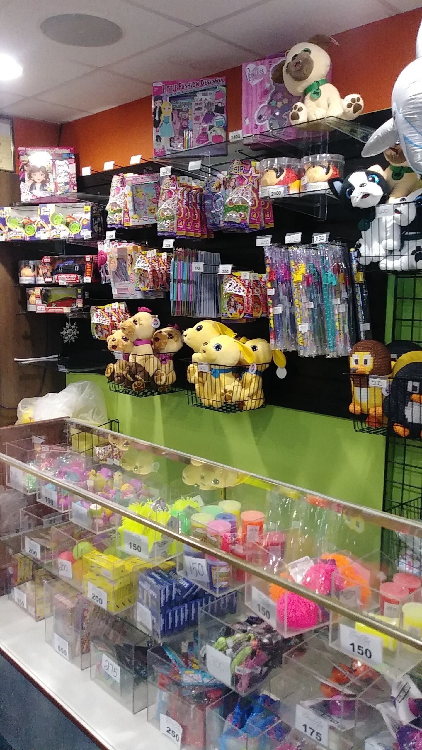 A toy store with various toys and games displayed on shelves and in bins.