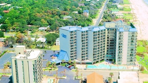 Un hôtel composé de plusieurs immeubles de grande hauteur, doté d’un parking et offrant une vue sur la plage.