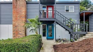 A modern two-story house with a brick chimney, a red door, and a blue door. - Downtown Kirkland - Luxury 3rd Street Retreat (Kirkland)