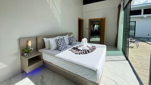 A modern bedroom with a large bed, a nightstand, and a view of the outside. - SKYPOOL,new brand villa with big private (Tambon Rawai)