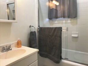 Combined shower/tub, hair dryer, towels, soap