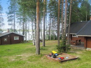 A cabin with a deck and a small play area with toys. - Honkaranta by Interhome (Karstula)