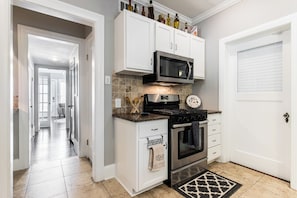 Enjoy cooking in this well-equipped kitchen with a gas stove, microwave, and stainless steel range hood.