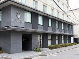 A modern hotel building with a prominent entrance, large windows, and a clean facade.