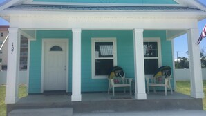 A two-story house with a porch, a front door, and two windows. - Cottage by the beach ! Short 120 steps to the beach and its beautiful waiting ! (Mexico Beach)