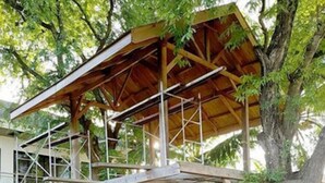 A two-story building with a wooden deck and a covered area. - El Pueblo De Hermano by Cocotel (Lian)