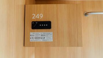A wooden door with a numbered panel (249) and a control panel with lock and unlock buttons.