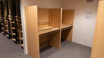A room with a bunk bed, a desk, and a chair.