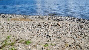 A rocky shoreline with a view of the sea.