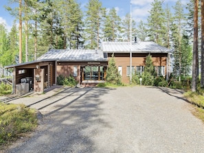 A lodge with a gravel driveway, wooden exterior, and a sign reading 'PIELISLINNA'. - Pielislinna/loma-koli by Interhome (Lieksa)