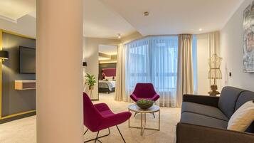 Junior Suite | Living area | 40-inch flat-screen TV with cable channels, TV
