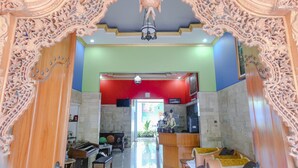 An ornate lobby with a grand chandelier, a reception desk, and a piano. - Hotel O Guest House Amalia Malang (Malang)
