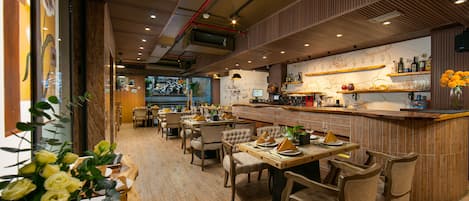 A restaurant with wooden furniture, a bar area, and a view of the street outside.