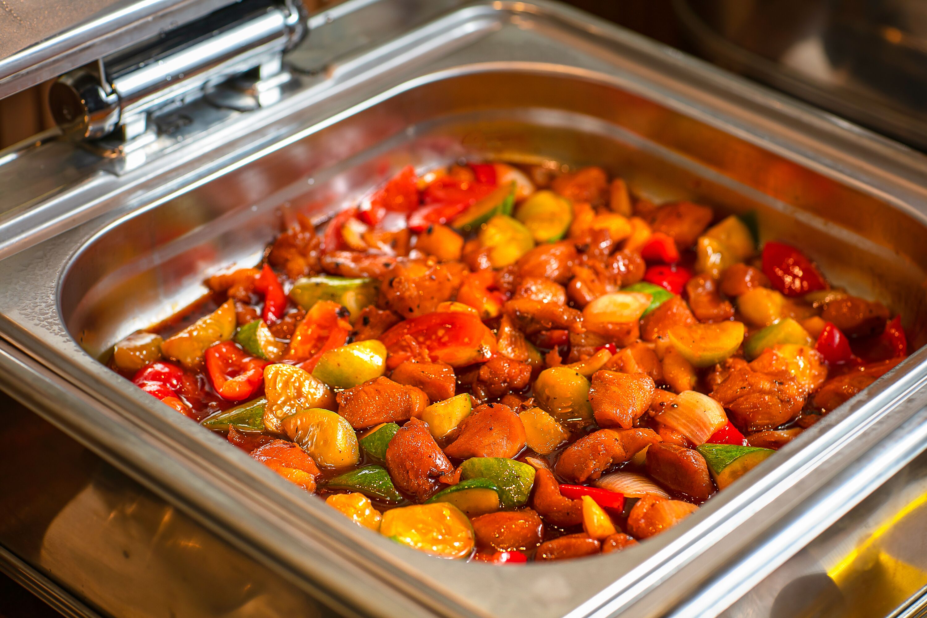 A buffet with a variety of cooked vegetables and meats.