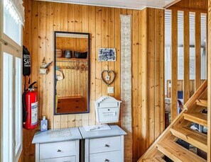 Comfortable room with a mirrored wardrobe, dresser, and staircase.