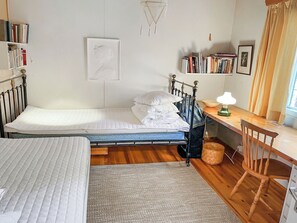 A bedroom with a bed, a desk, a chair, a bookshelf, and a window. - Ranta-iivari by Interhome (Lohja)