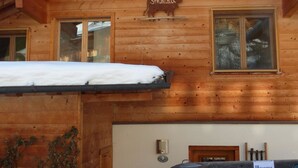 A wooden cabin with a sign reading "Strubelblick" and a stove in front. - Strubelblick EG by Interhome (Lenk)