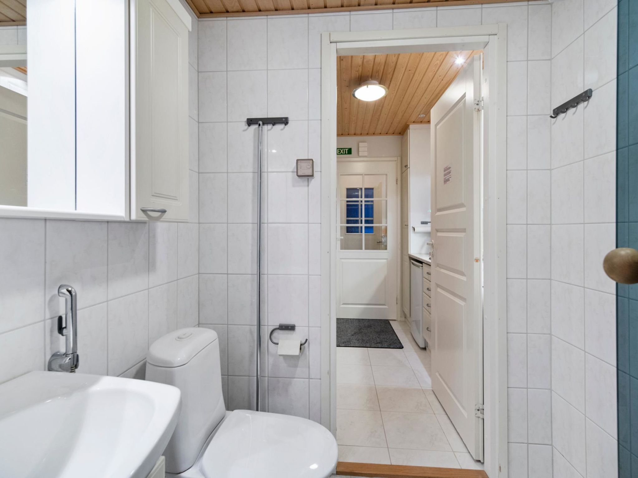 A bathroom with a toilet, sink, and shower.
