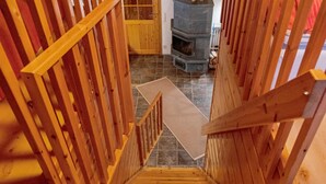 A wooden staircase with a handrail leading to a tiled floor. - Tunturitähti by Interhome (Äkäslompolo)