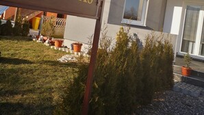 A sign for a house named "HOUSE KARAKAŞ" with a clear view of the building's exterior, including a window and a door. - House Karakas (Plitvicka Jezera)