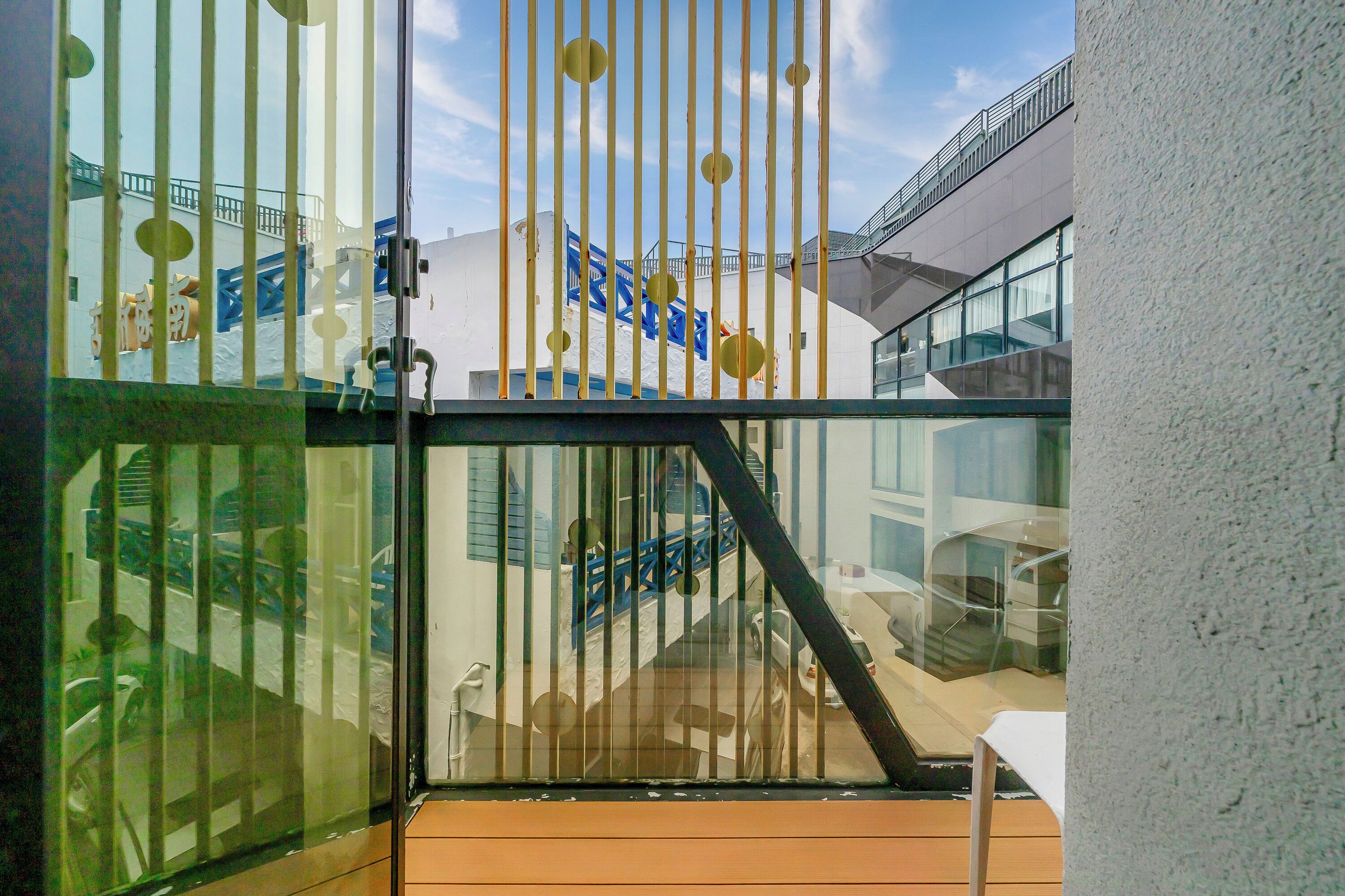 A modern building with a glass facade, a staircase, and a railing.