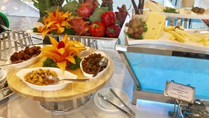 A buffet with various food items including cheese, fruits, and nuts. - DQua Hotel (Nha Trang)