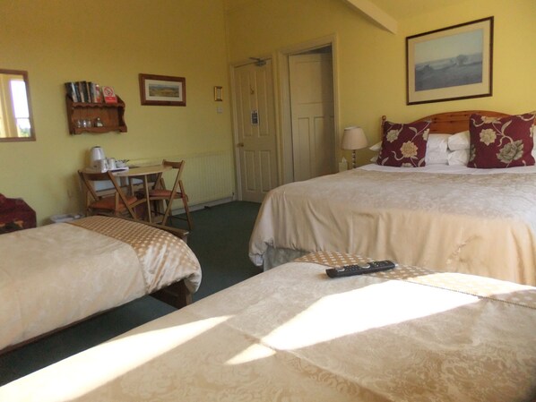 Desk, iron/ironing board, bed sheets