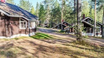 A log cabin-style building with a dirt path leading to a staircase.