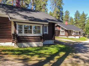 A log cabin with a porch, a window, and a door. - Honkakoli 9/1 by Interhome (Lieksa)