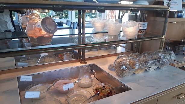 A bakery display case with various baked goods and containers. - Haus Seeblick (Neuwerk)