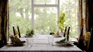 A dining table set for four with plates, glasses, and cutlery. - Sel Guesthouse (Selfoss)