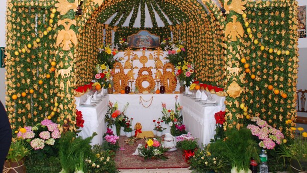 A religious altar with a floral arch, candles, and religious icons. - SEGESTA - Le Bouquet (Salemi)
