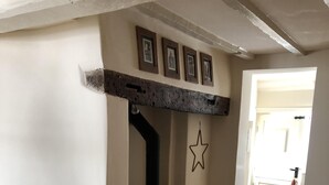 A cozy room with a stone fireplace, a star decoration, and a table with a book and cookies. - Award Winning Little Gem on the Historic Cartway (Bridgnorth)