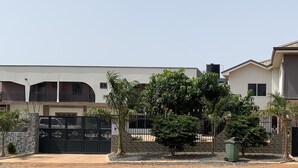 A two-story building with a sign for 'Dafik Lodge'. - Dafika Lodge (Tema)