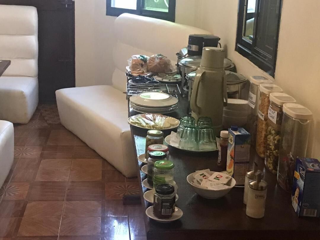 A dining area with a table set for a meal, including plates, glasses, and condiments.