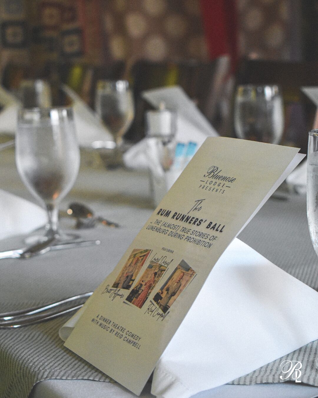 A menu card titled "Bluenose Lodge - Presley's" featuring "Two Runners' Ball" with a subtitle "The Almost True Stories of Lunenburg During Prohibition".