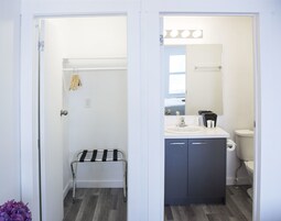 Un baño con lavamanos, inodoro y toallero.