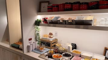 A buffet with various food items and condiments.