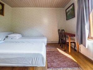 A bedroom with two beds, a wooden desk, and a chair. - Palttala by Interhome (Tampere)