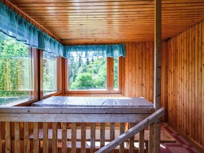 A wooden cabin with a loft bed, large windows, and a view of greenery. - Palttala by Interhome (Tampere)