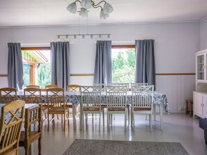 A dining area with a table set for four, surrounded by wooden chairs. - Palttala by Interhome (Tampere)