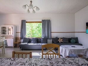 A room with a bed, a table, a chair, a cabinet, and a window with curtains. - Palttala by Interhome (Tampere)