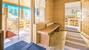 A wooden cabin interior with a wooden bench, a staircase, and a view of the outside. - Palttala by Interhome (Tampere)