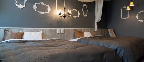 A modern bedroom with two beds, ornate wall mirrors, and a chandelier.