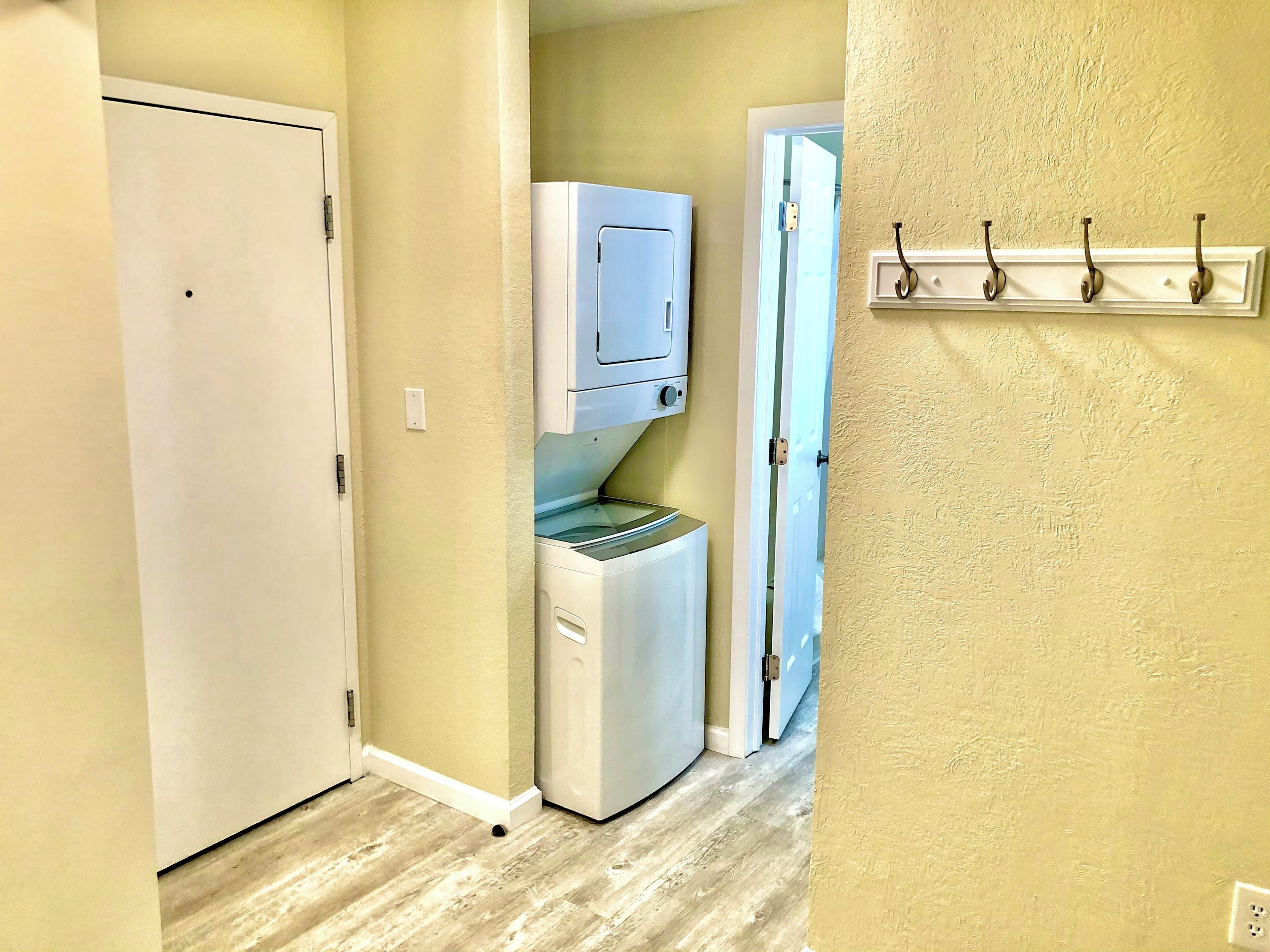 A laundry room with a washing machine, dryer, and a water dispenser.
