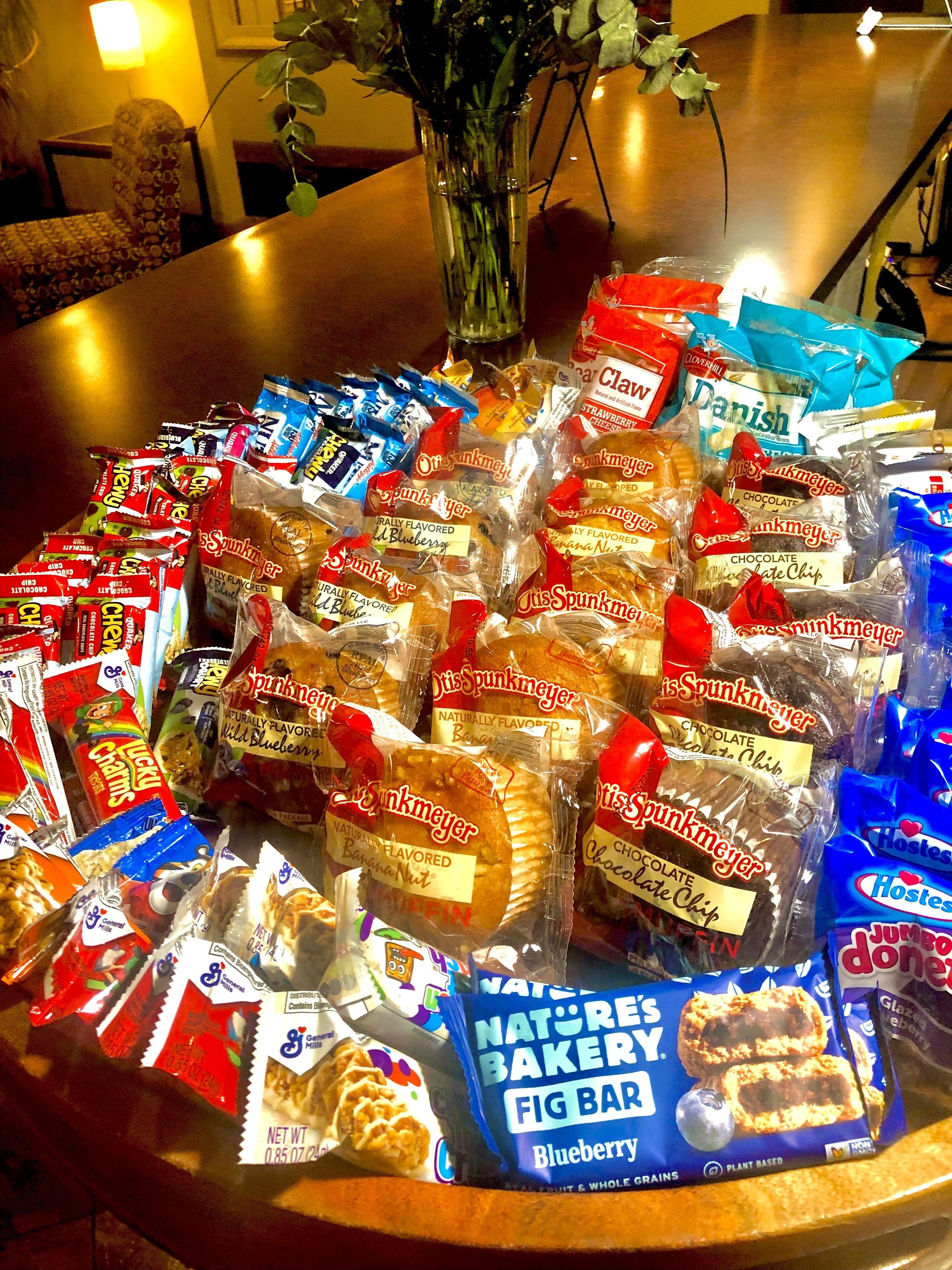 A table with various packaged snacks and baked goods, including 'Spunkmeyer' and 'Hostess' brands.
