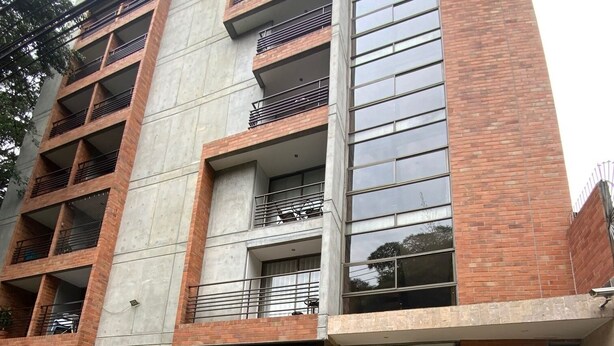 A multi-story building with a staircase leading to the entrance.